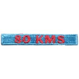 The words 80 KMS are stitched in red on a blue background. 