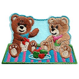 Two teddy bears sit on a picnic blanket eating a picnic. 