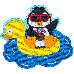 A penguin on a duck floaty holding a coconut.