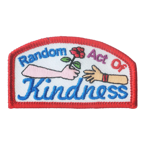 The words Random Act Of Kindness are around two hands passing a flower.